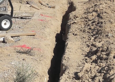 hand dug trench, 30 feet, 4 feet deep, caliche soil (cement like)